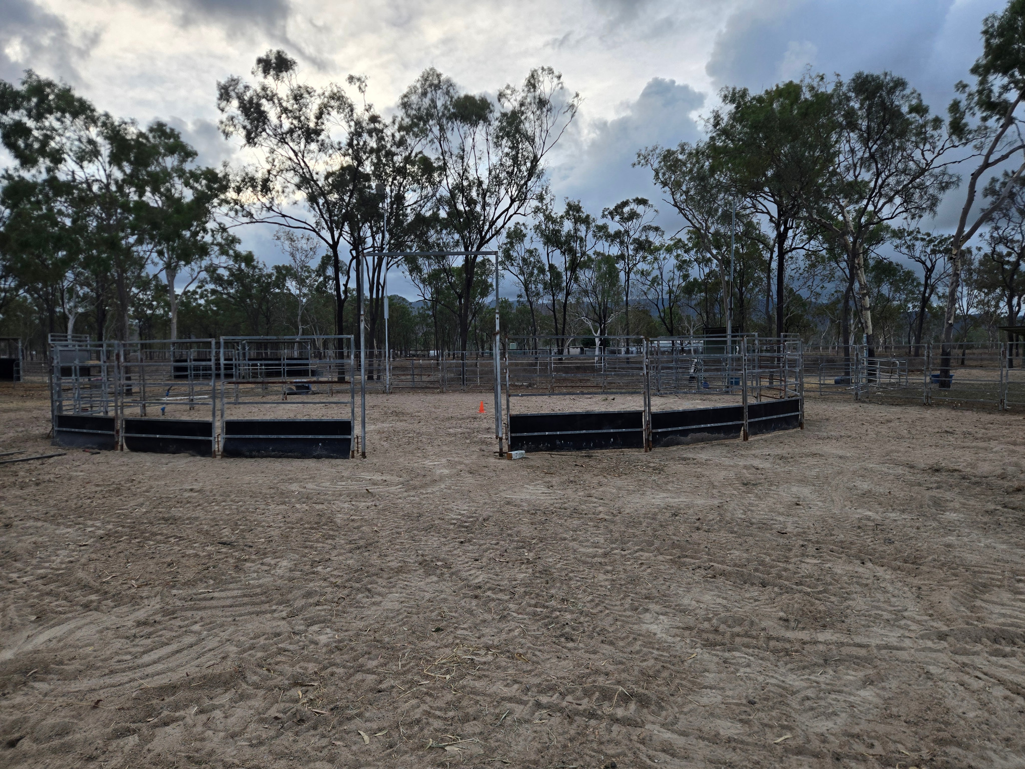 Actual daylight photograph of the roundyard, its fenced entrance and surrounding trees, without an event styling setup